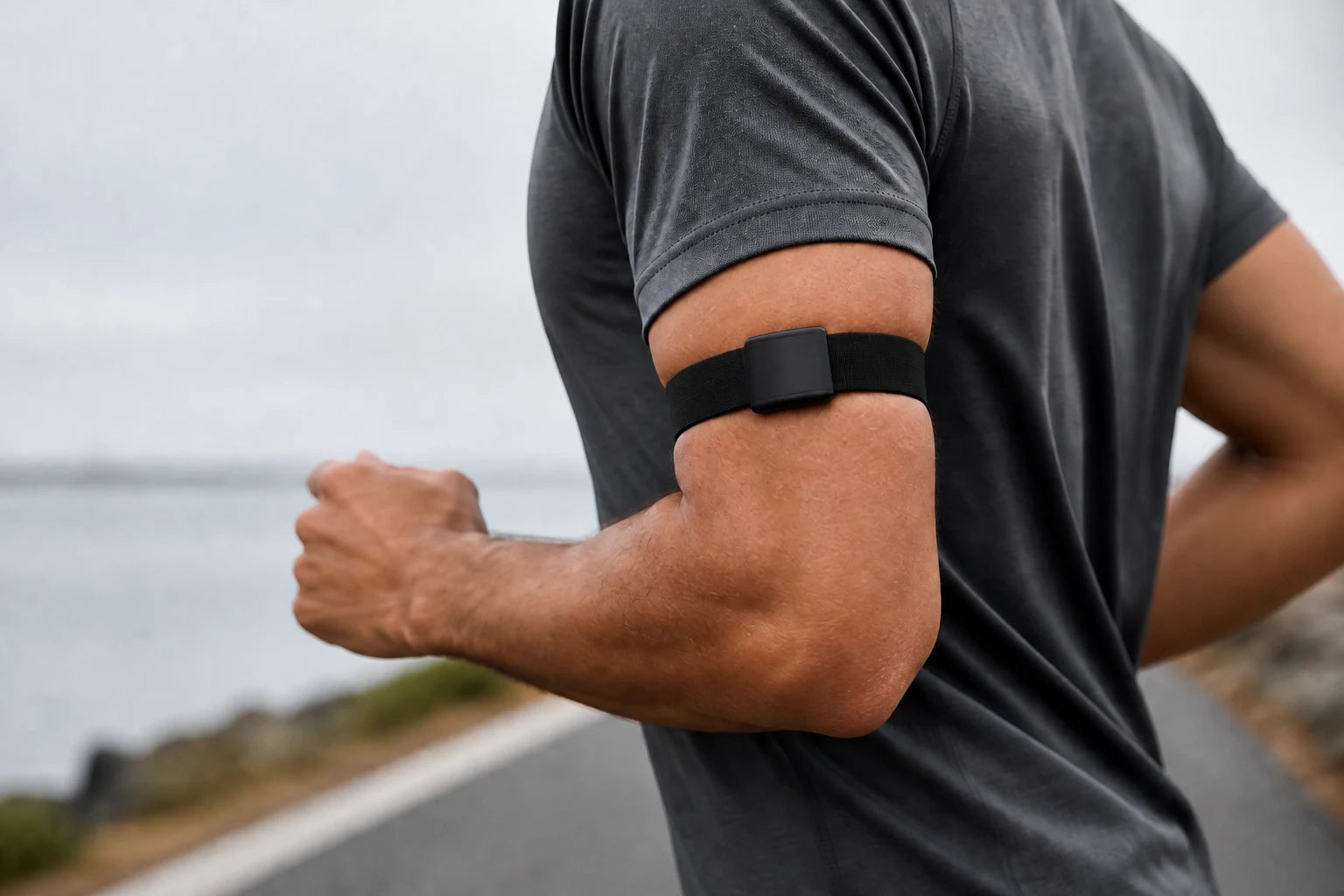 Runner wearing a narrow screenless tracker band around the upper arm